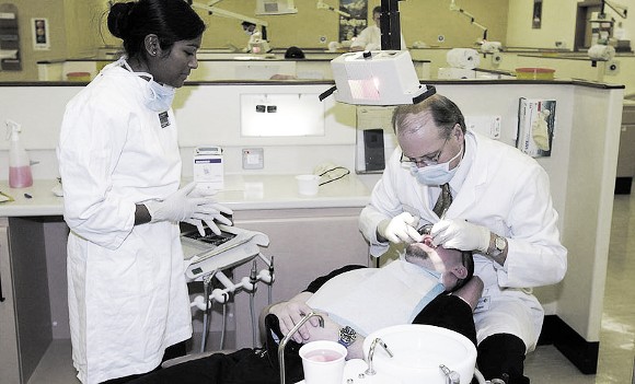 Dentist and assistant treating a patient